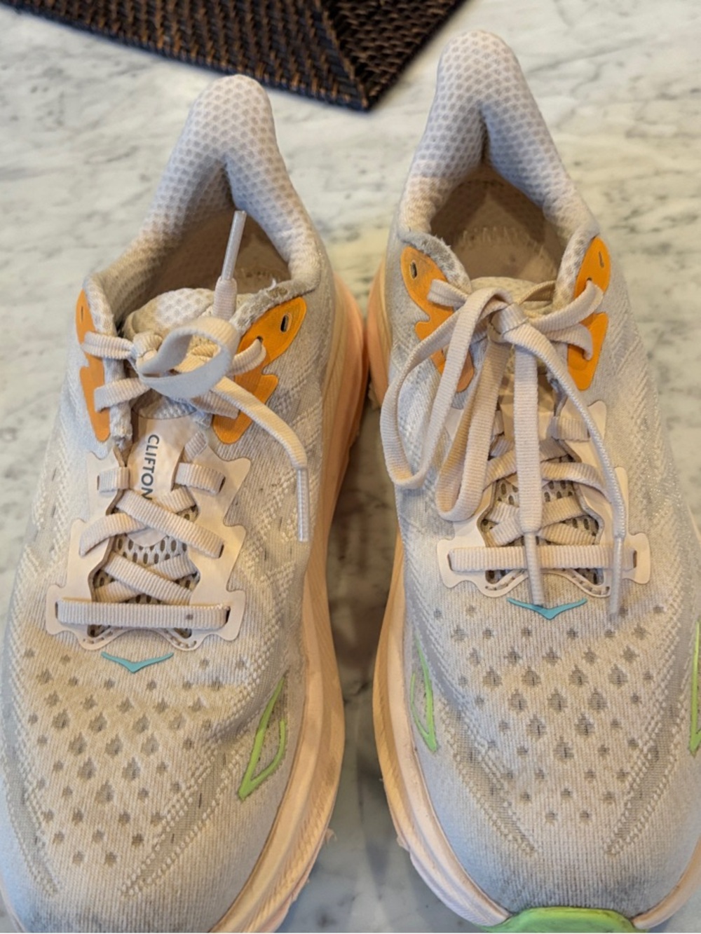 Hoka Clifton 9 Running Shoes with Neon Green and Orange Accents. 7 D wide